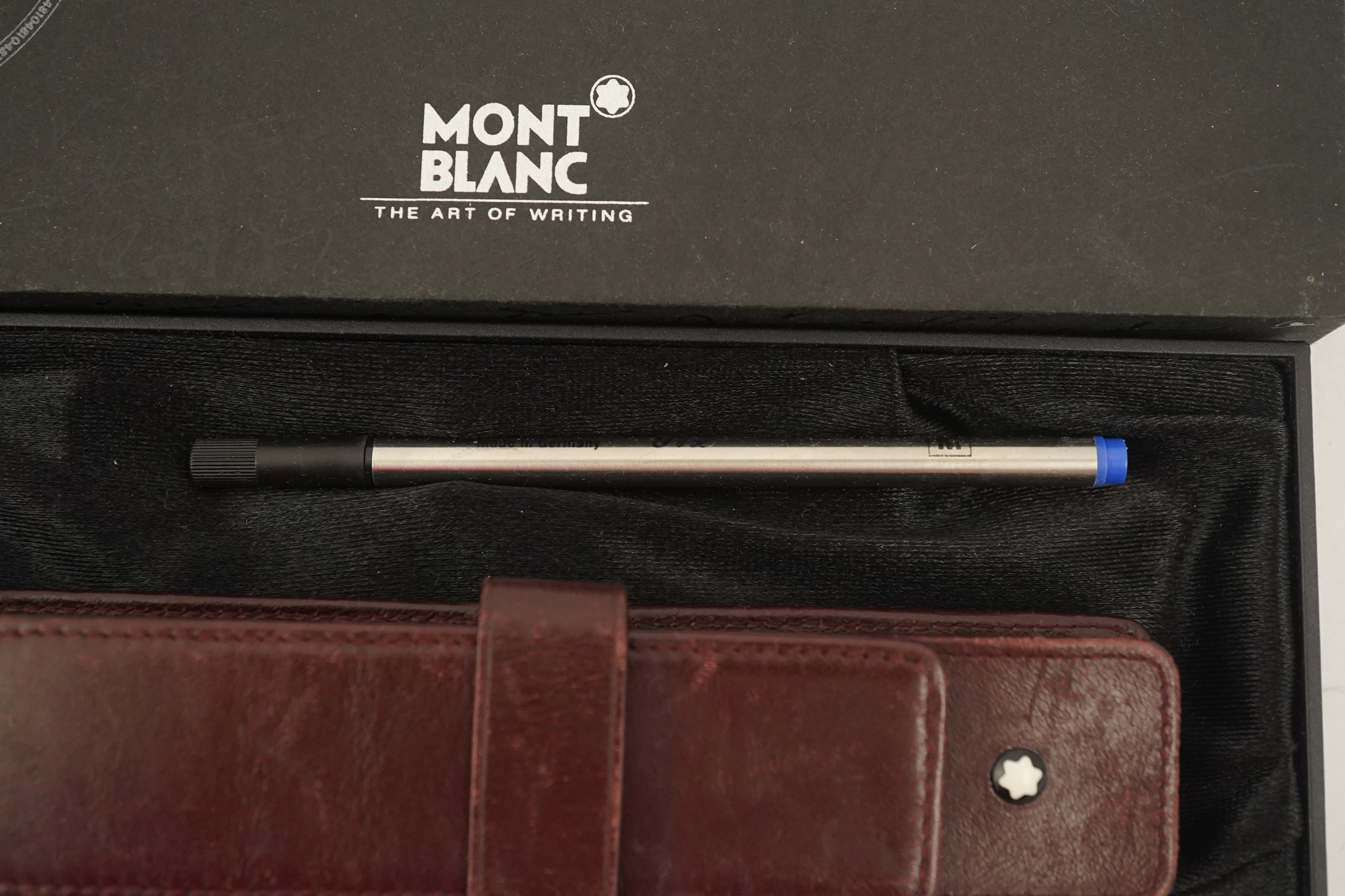 A Mont Blanc Meisterstuck maroon and gilt rollerball pen, boxed with paperwork and leather case